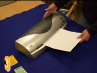 Photo of lamination sleeve being put into machine