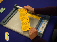 Photo of person cutting sheet into wallet cards